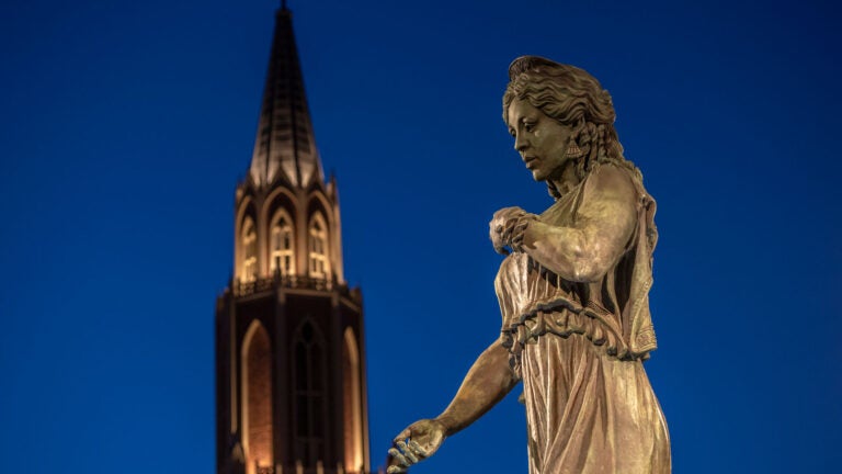 Hecuba's statue at dusk with the USC Village tower in the background