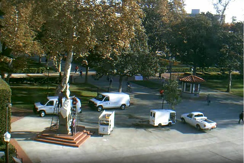 Tommy Trojan getting wrapped in sliver tape