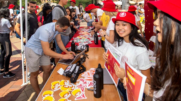 Students behind booths working the Undergraduate Student Government involvement fair.