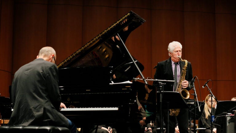 Pianist and Saxophonist playing together on stage.