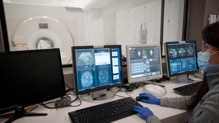 Researcher looks at the results of an MRI scan as it is happening.