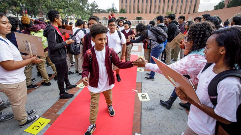 Elementary school students walking the red carpet into USC to participate in the USC McMorrow Neighborhood Academic Initiative Saturday Acadmey kickoff