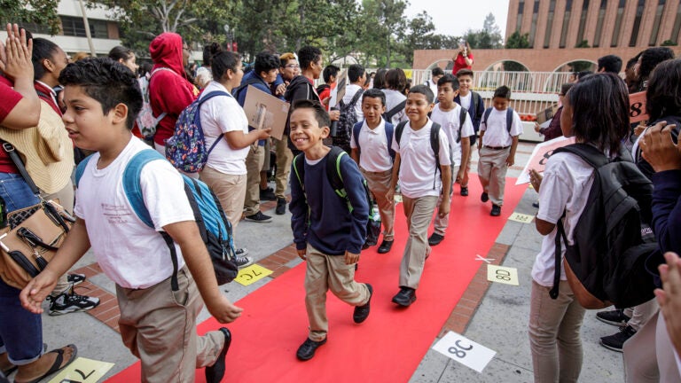 Young students walk the red carpet at USC to the USC McMorrow Neighborhood Academic Initiative Saturday Academy Kickoff.