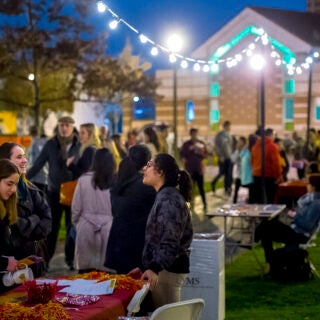 Freshmen talk to student organization representatives during an evening Spring Admit event