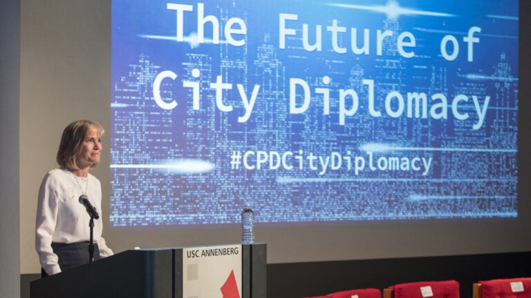 Women speaking at a podium for a presentation