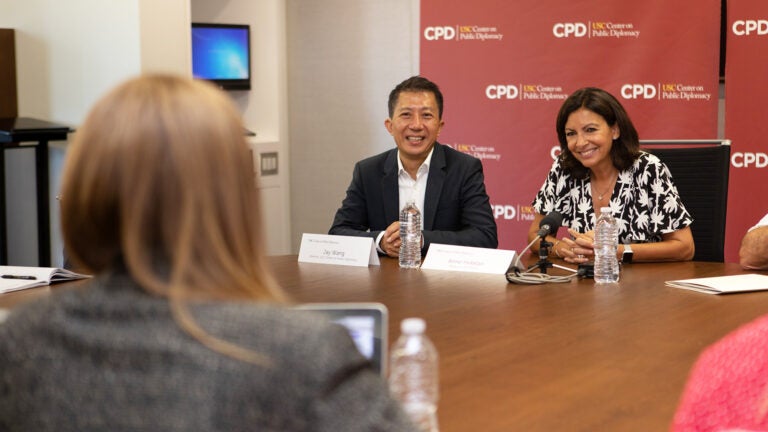 Individual interviewing a man and a women in conversation