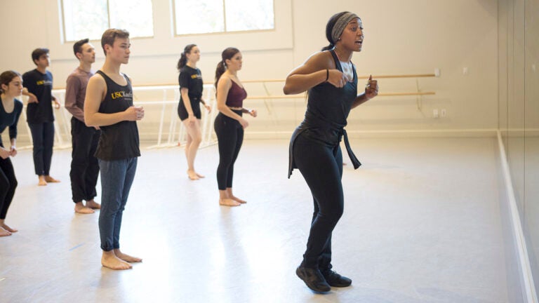 Dance teacher leading class in practice