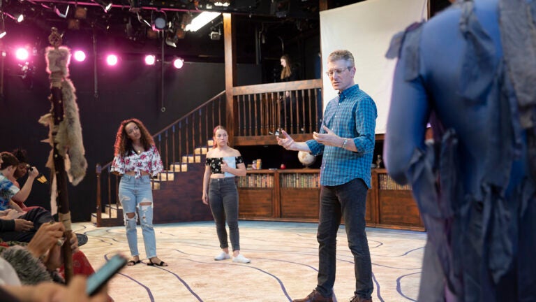 Driector instructing students in a performance of 