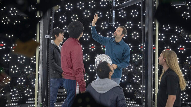 Teacher shows students the lgith stage used to create virtual characters.