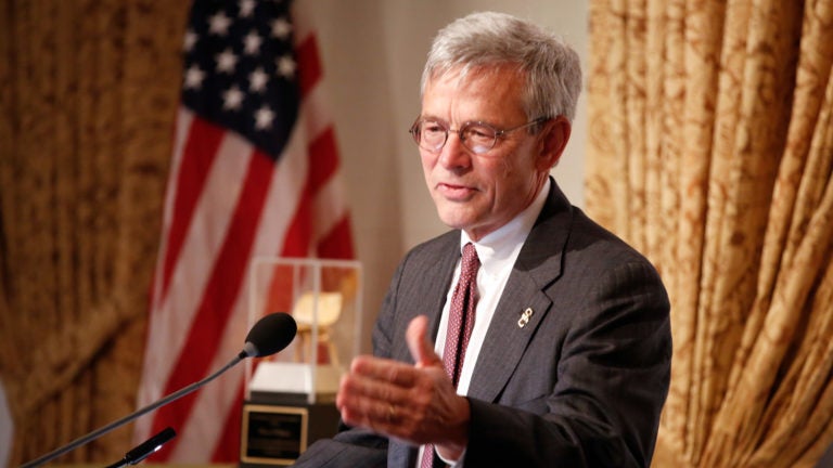Charles Zukoski speaking at a podium.