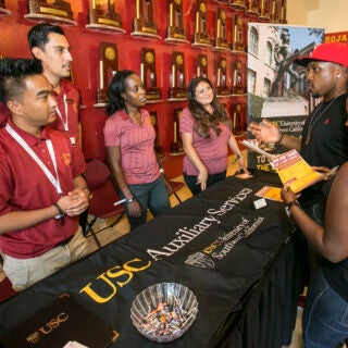 USC Auxiliary Services staff members answering questions during a job fair.