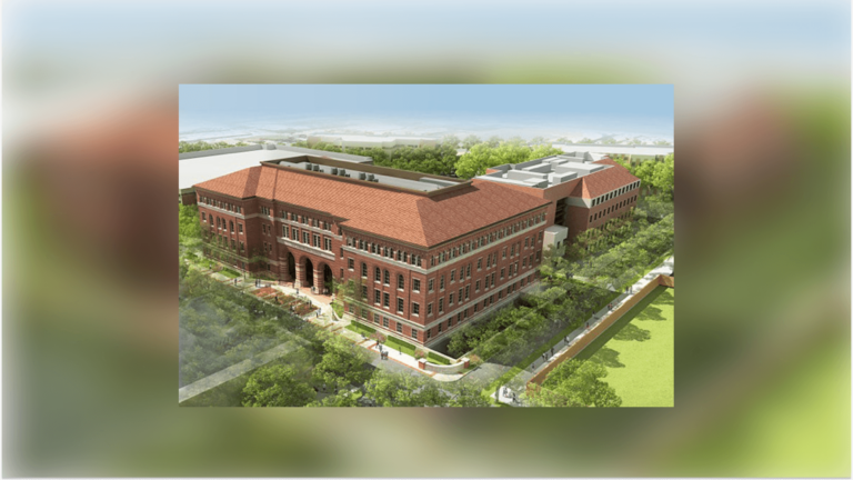 A model of the Michelson Center - a huge brick building surrounded by greenery.
