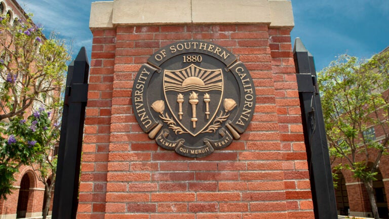 The USC seal on a column of a gate on the USC campus.