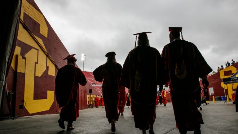 Graduates process into USC's 2020-21 commencement ceremonies for the Gould School of Law, the School of Cinematic Arts and the School of Dramatic Arts at the Los Angeles Memorial Coliseum, May 16, 2021. (USC Photo/David Sprague)