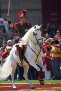 Traveler runs across the LA Coliseum field after a touchdown