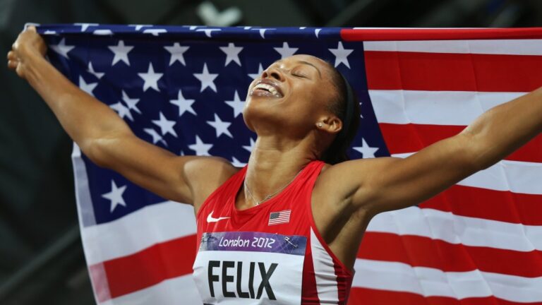 Allyson Felix holding up the American flag