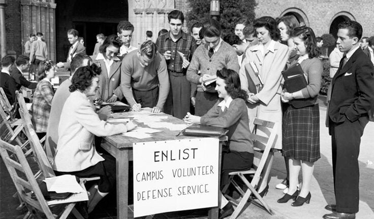 In black and white, students on campus signing up to be campus volunteers.