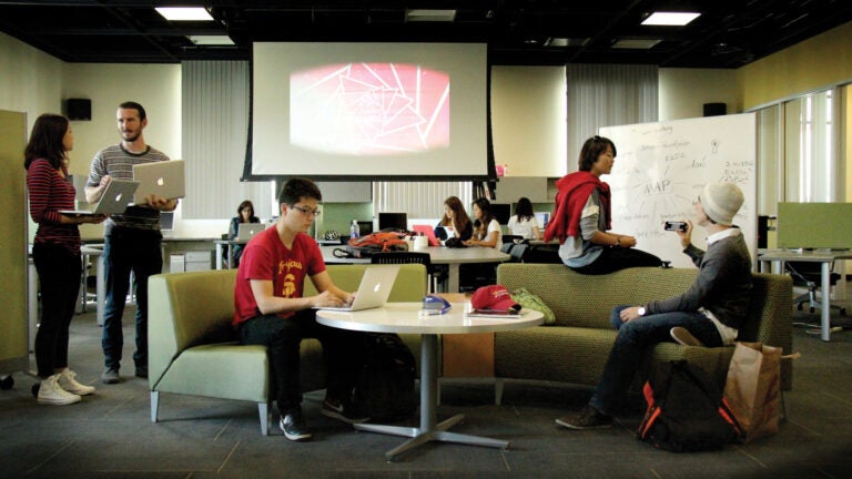 Students on laptops collaborate and share ideas at the Interactive Media Building at the USC School of Cinematic Arts.