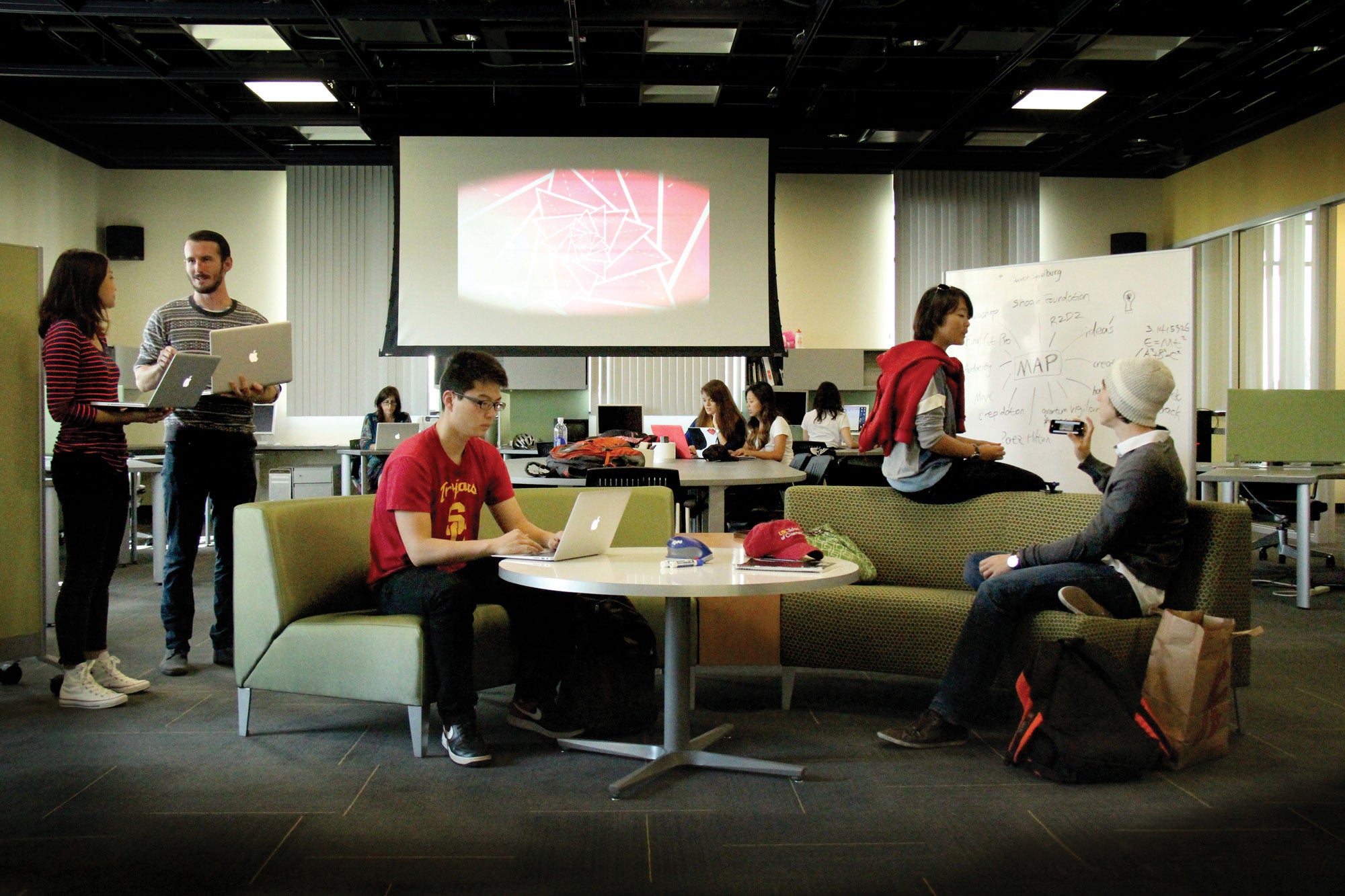 Students on laptops collaborate and share ideas at the Interactive Media Building at the USC School of Cinematic Arts.