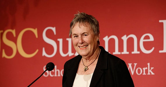 Suzanne Dworak-Peck on the podium in front of the microphone