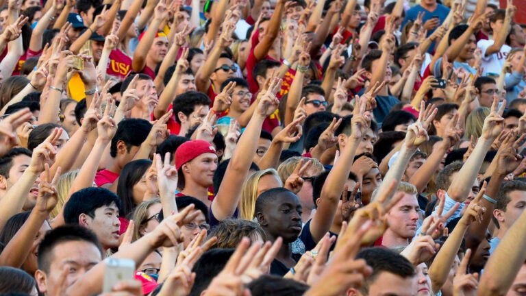 USC students raise the Victory sign during a spirit rally