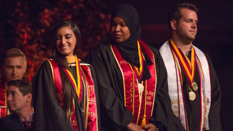 USC students wear medals of honor during a ceremony.