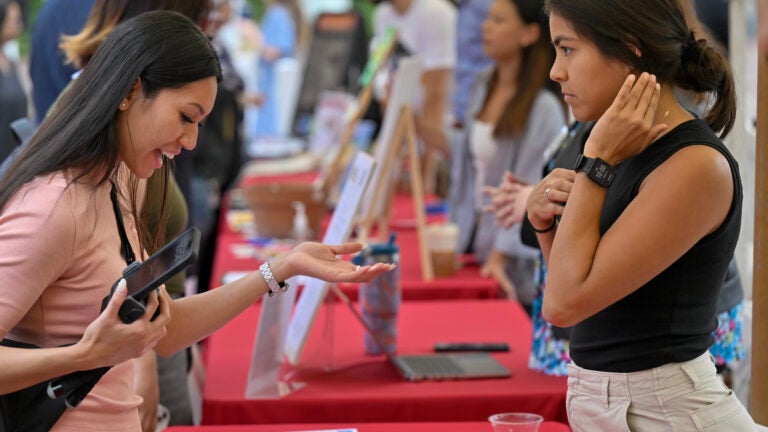 A student visits a booth at the USC Sustainability Hub Grand Opening
