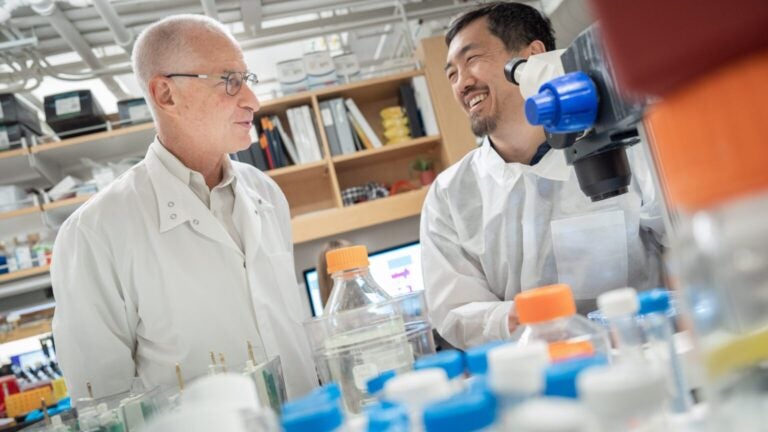 Dean Pinchas Cohen in a lab with a male researcher