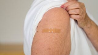 Person showing where they got vaccinated