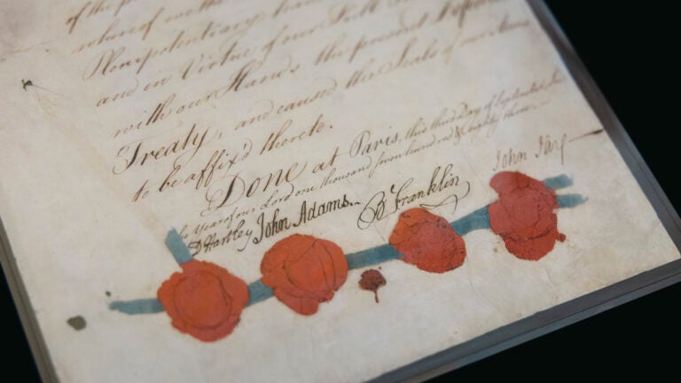 Historic document featuring handwritten text, signatures and red wax seals.
