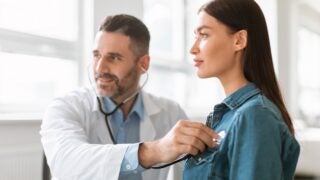 Female patient with male clinician and stethoscope